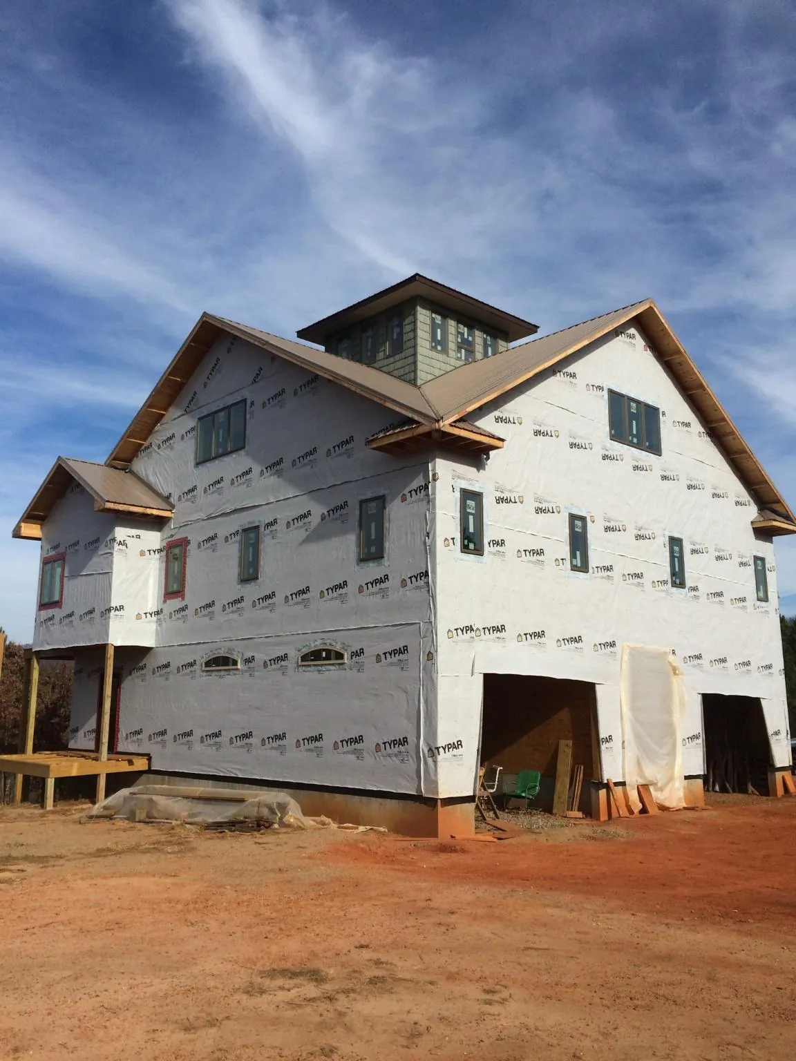 New two story house under construction with a cupola and gabled roofs in Lebanon